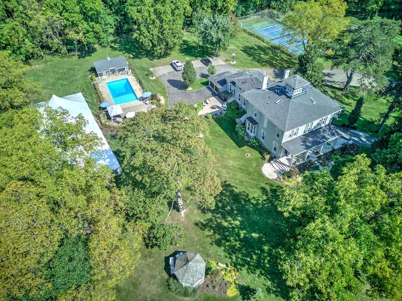 Aerial view of the Villa on Verona with pool, tennis court and lawn.