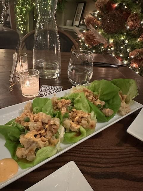 Lettuce Wraps at a dinner table with wine